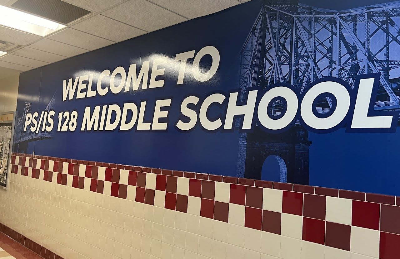 A hallway mural that reads Welcome to PS/IS 128 Middle School, above red and white tiles.