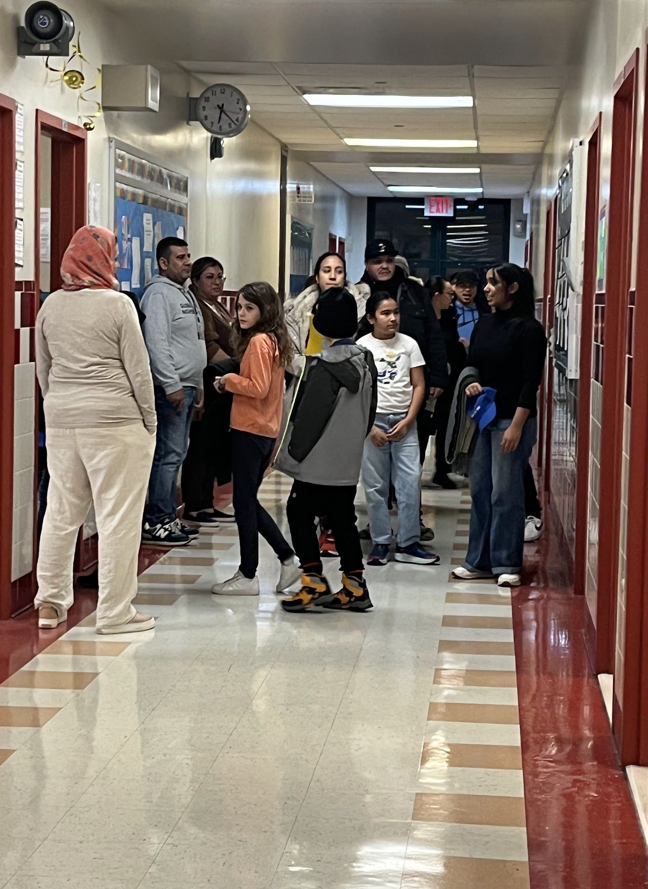 Students and families line a school hallway during the middle school showcase.